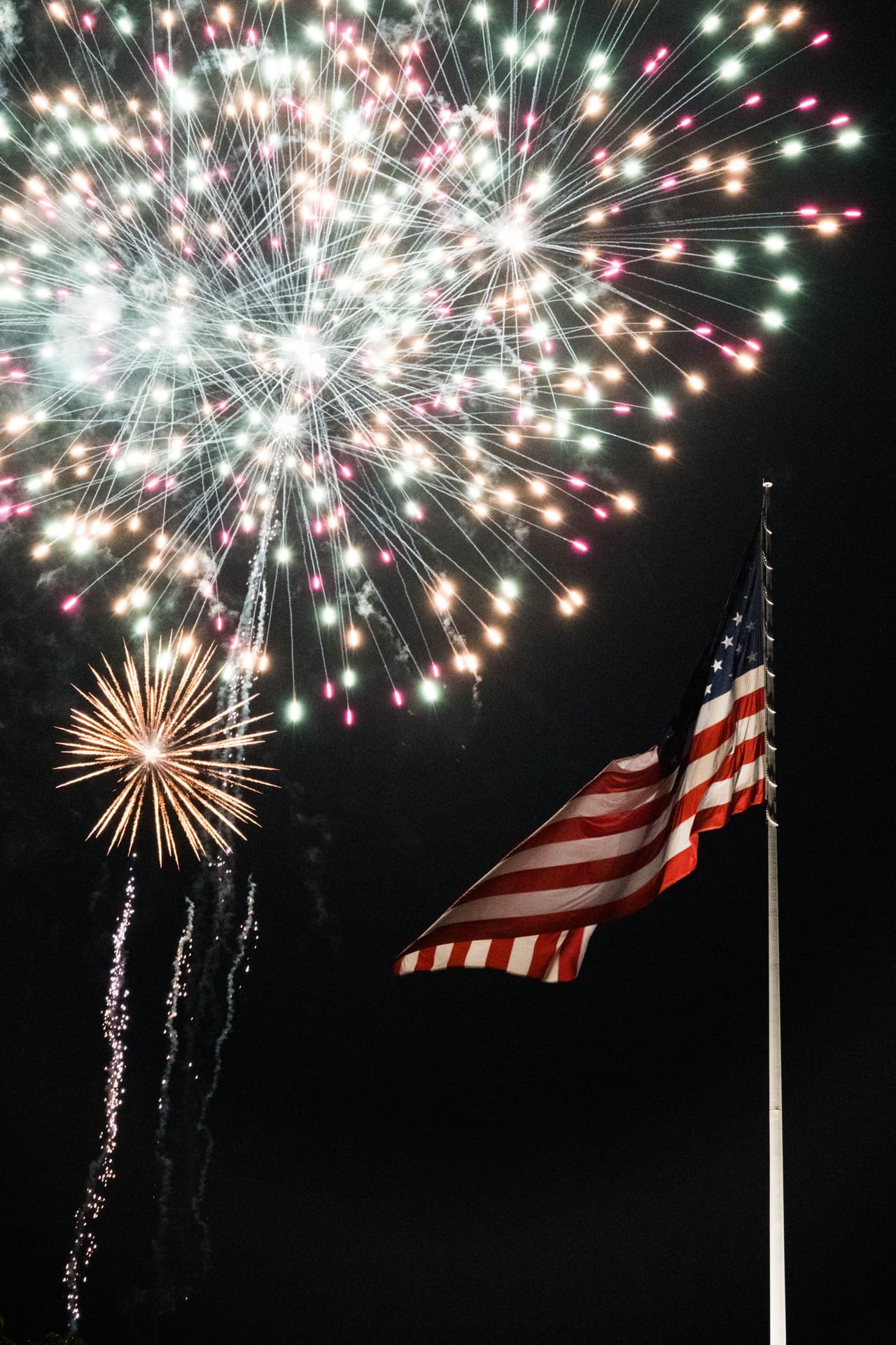 Fireworks over an American flag on Independence Day