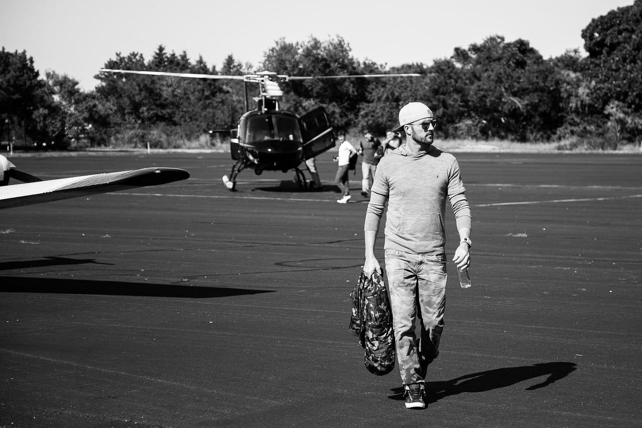 A helicopter and small aircraft on the ramp at East Hampton Airport in the Hamptons