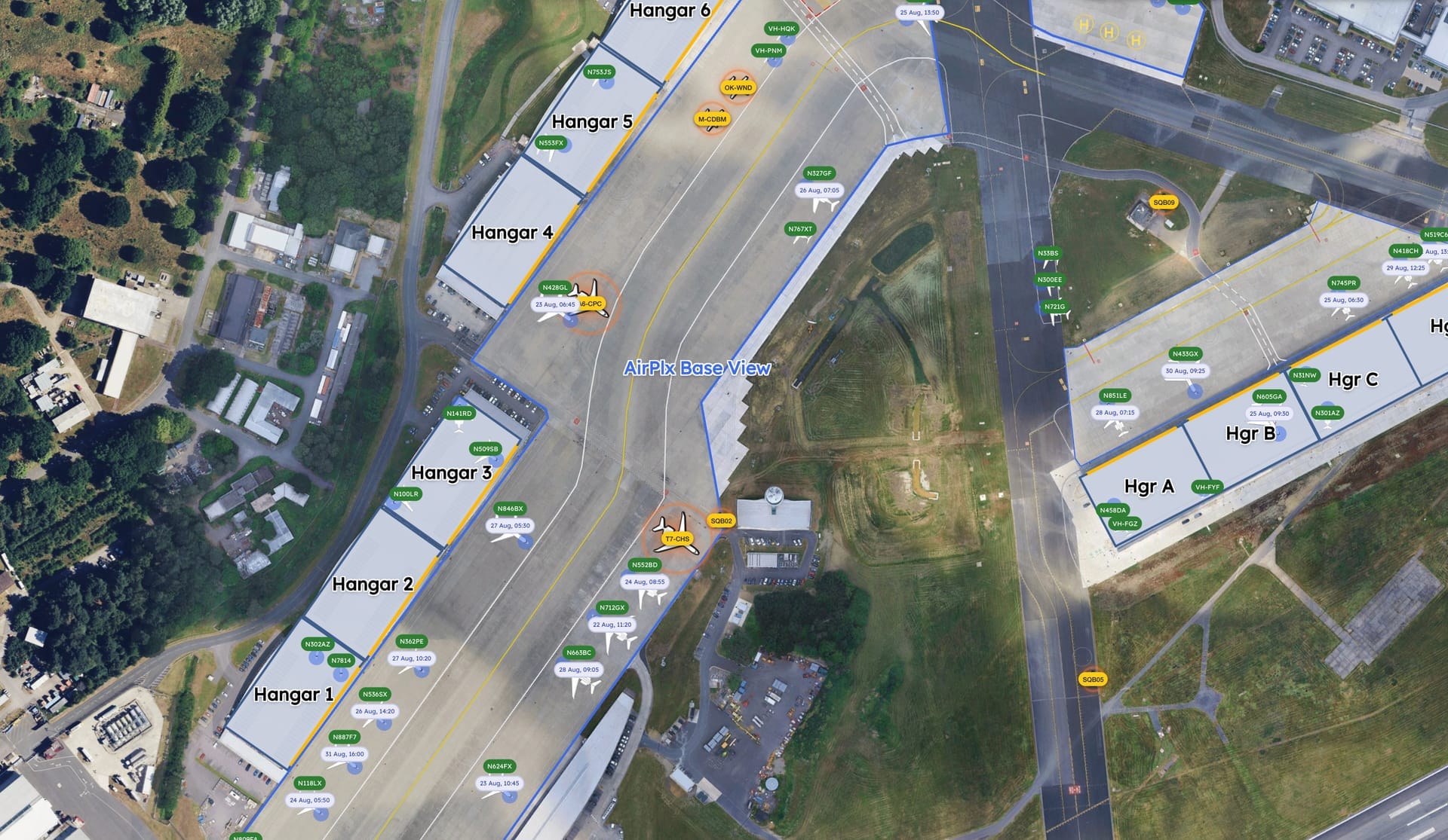 AirPlx Base View with ADS-B on, showing the whole field on satellite: six hangars and their ramps down one side, three more across the field, every based aircraft labeled with its tail number, and live ADS-B traffic ringed in amber where it is moving on the ground
